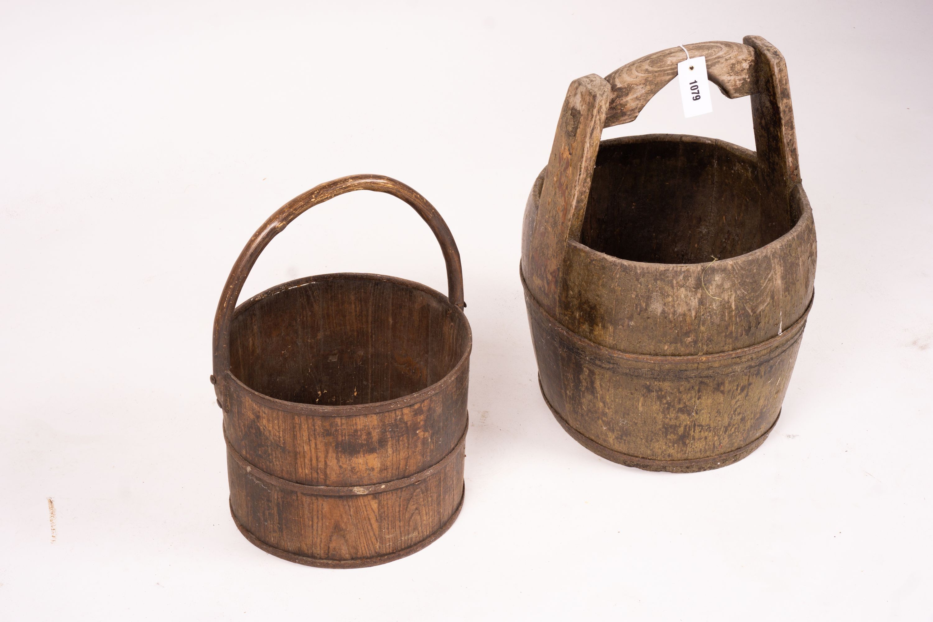 A Chinese staved wood rice carrier together with a circular iron bound staved wood bucket, larger 35cm diameter, height 52cm